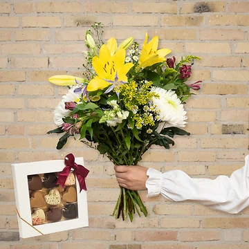 Send en smuk og trendy forårsbuket med chokoladehjerter og liljer